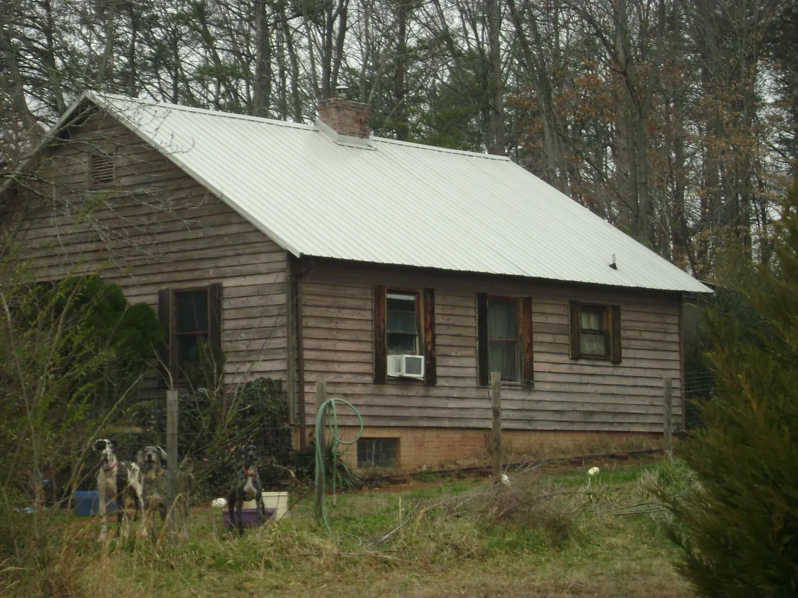 White metal roof on an old wood sided farmhouse, from a Asphalt Shingle Roof Repair job in Lake Saint Louis